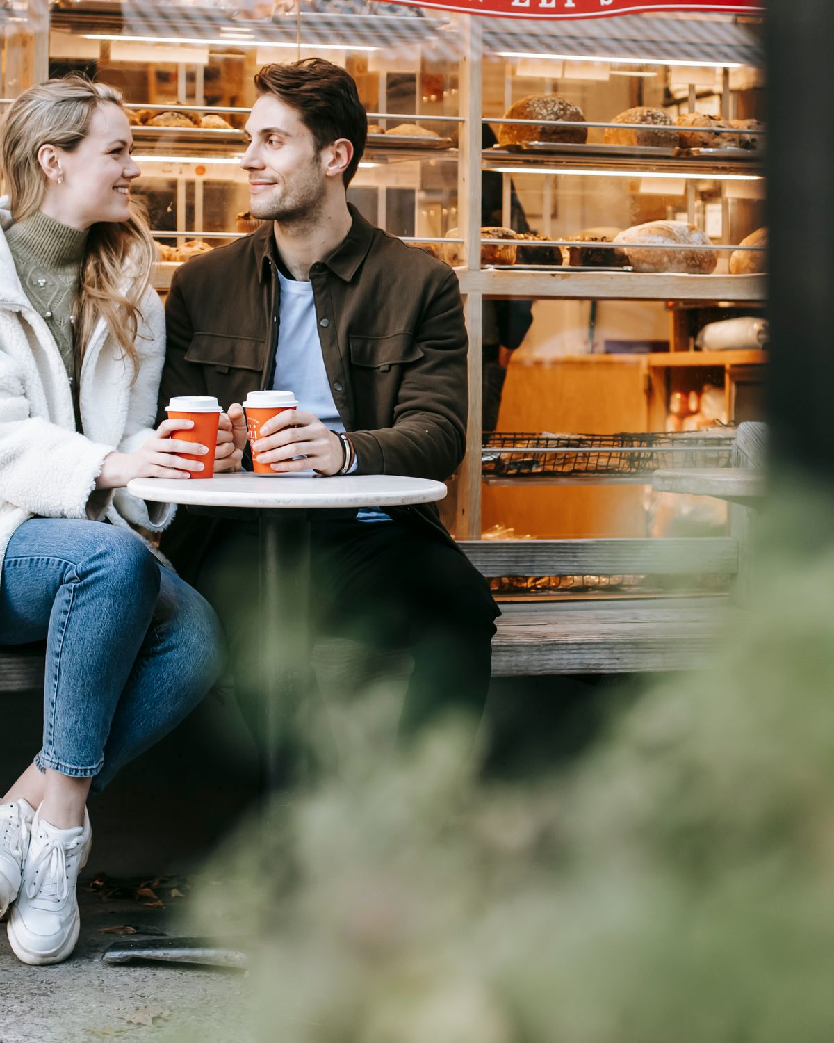 A man and a woman talking warmly over coffee